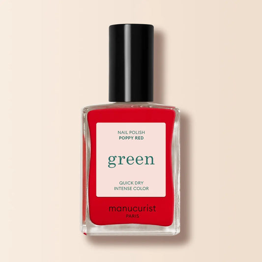 Red nail polish bottle with black cap on a beige background