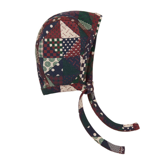 Colorful patchwork baby bonnet on a white background