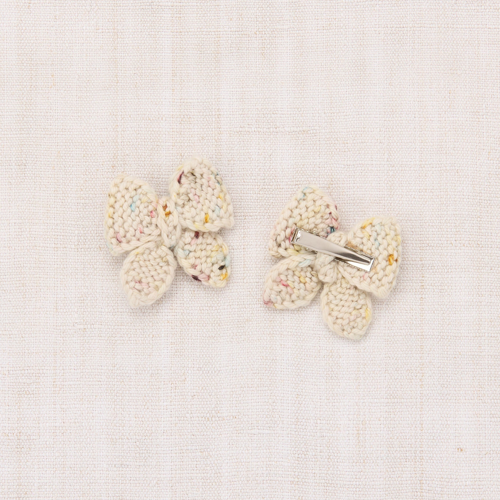 Pair of butterfly-shaped earrings on a light background