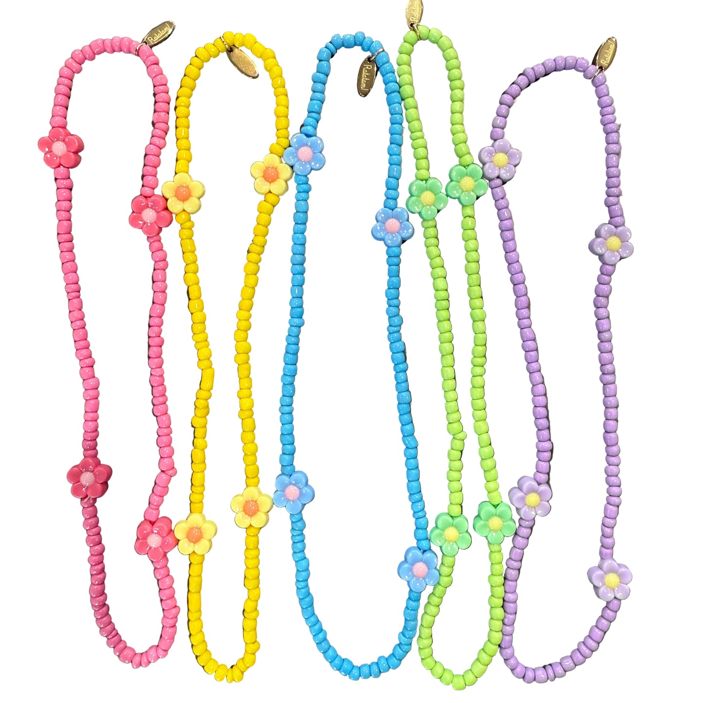 Colorful beaded necklaces with floral ends on a metallic surface