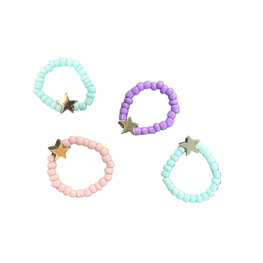 Set of beaded bracelets with star charms on a textured surface