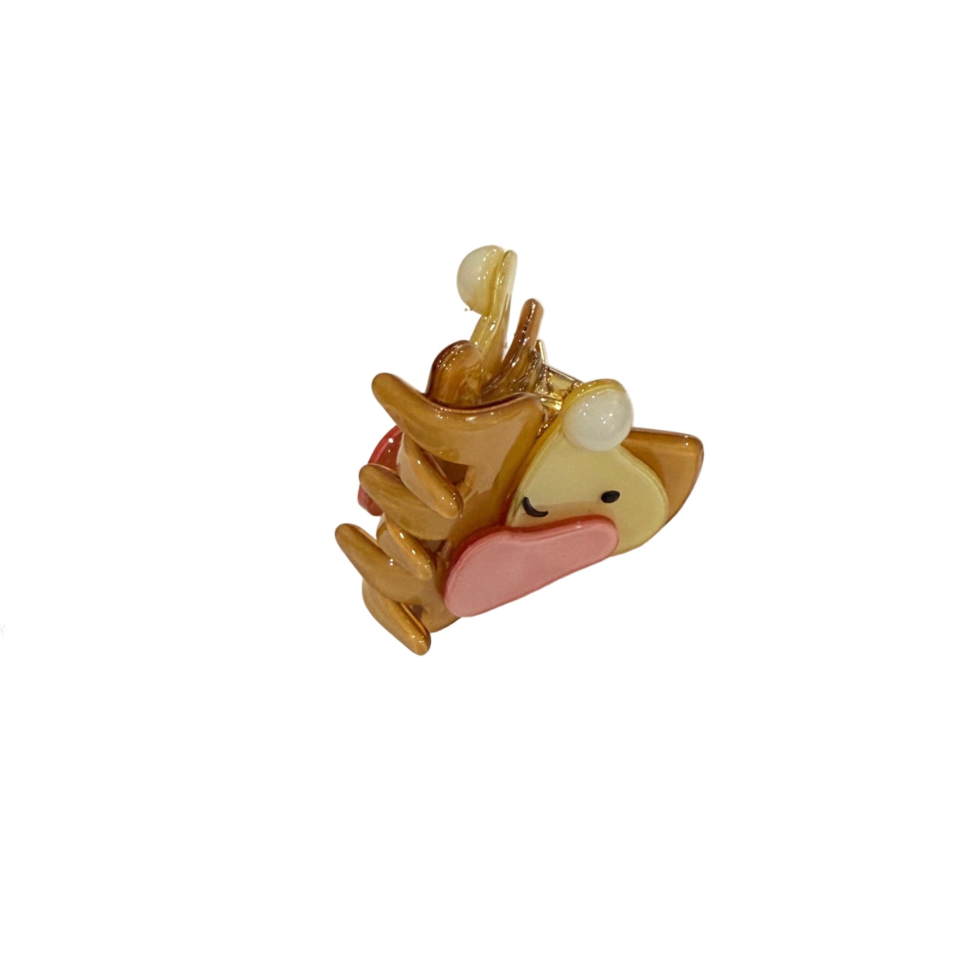 Small bear figurine on a business card with 'LITTLE LESH' branding on a metal surface.