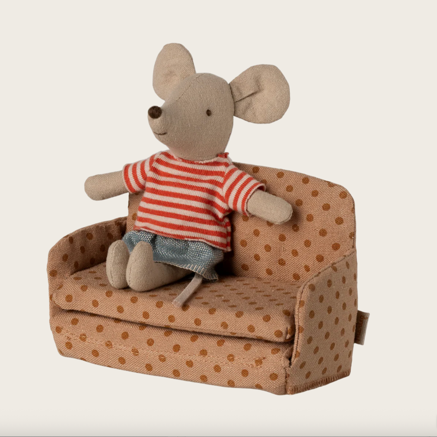 Stuffed toy mouse in a striped shirt sitting on a polka dot chair