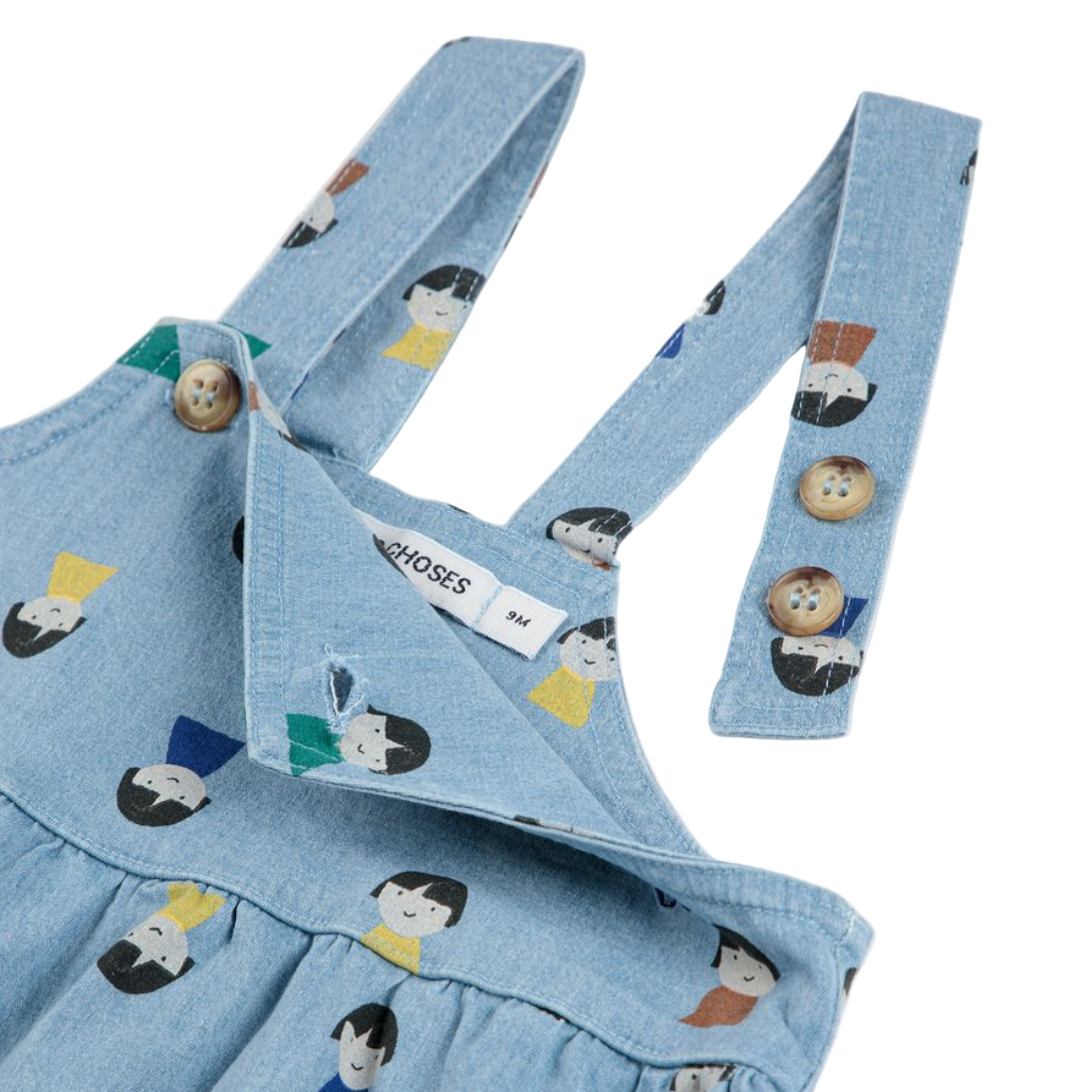 Blue denim dress with character print and matching suspenders on a white background