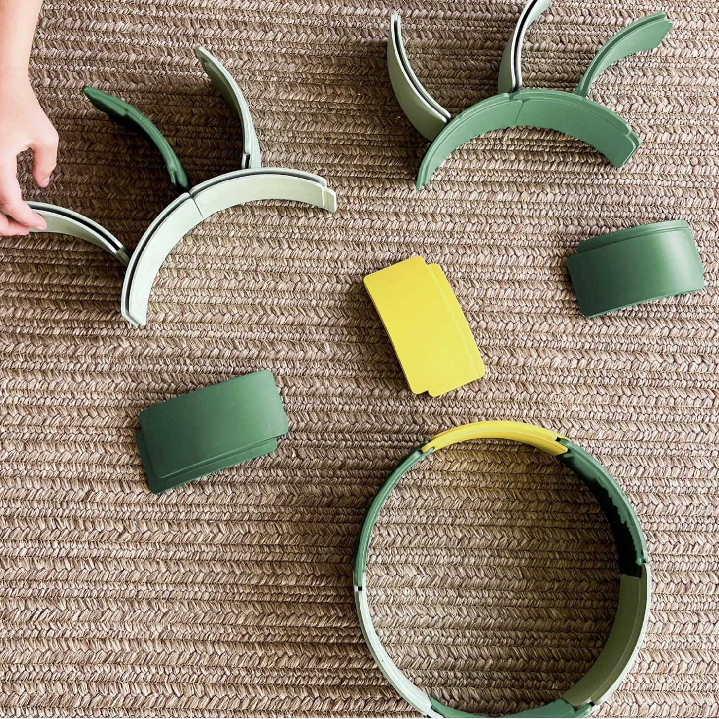 Green and yellow pet toys on a textured surface