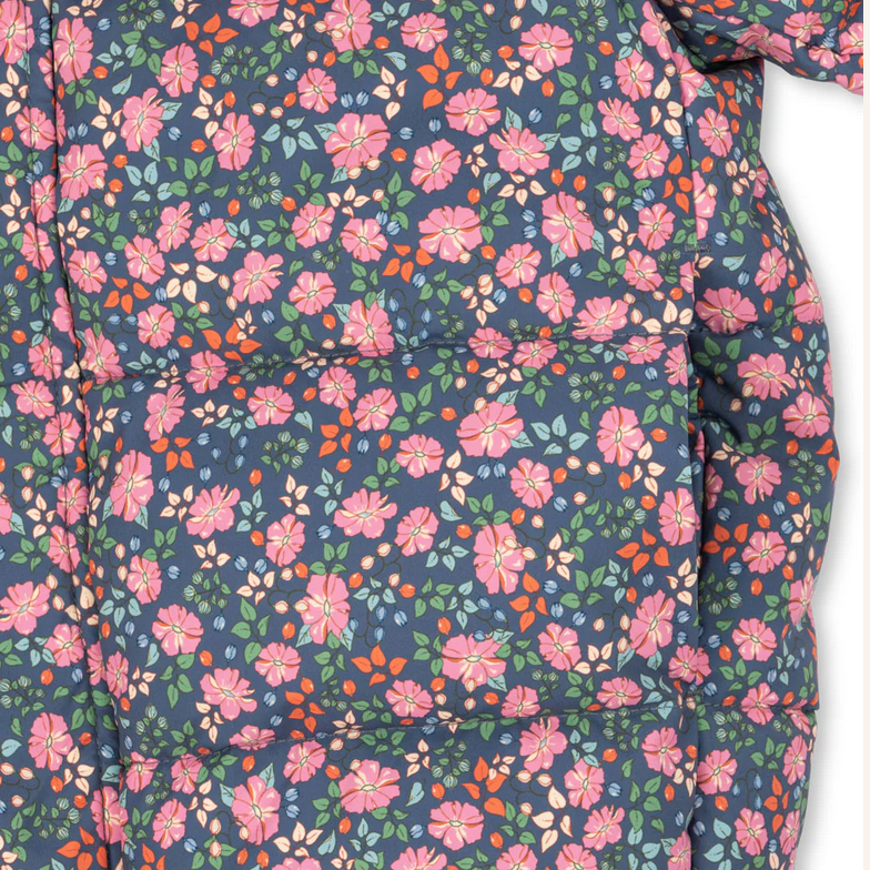 Floral patterned fabric with pink and green flowers on a blue background