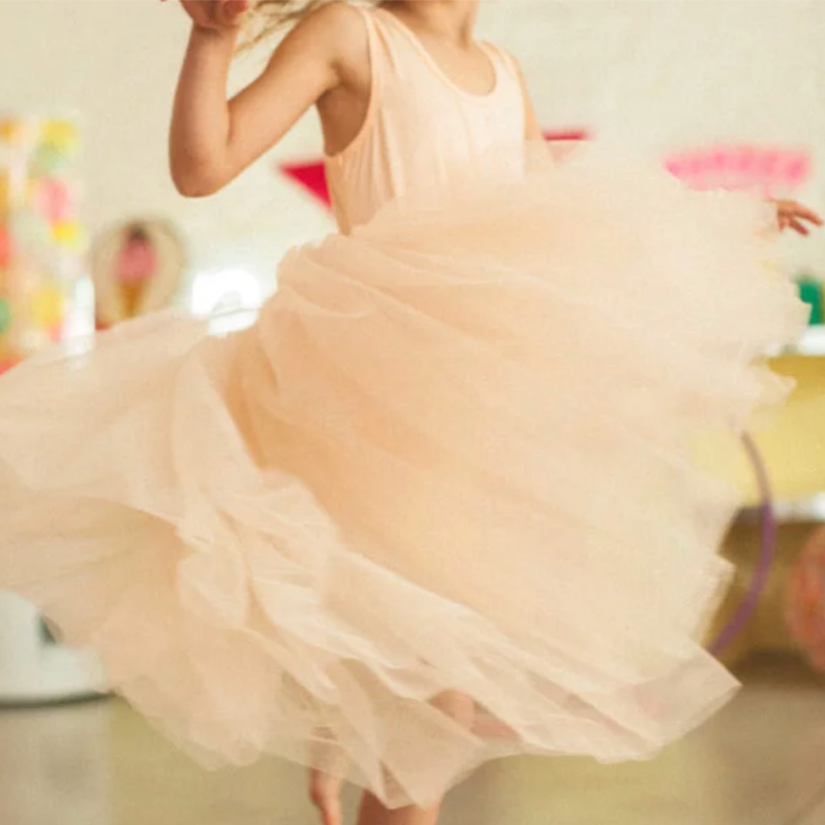 Person wearing a light pink dress with a blurred background