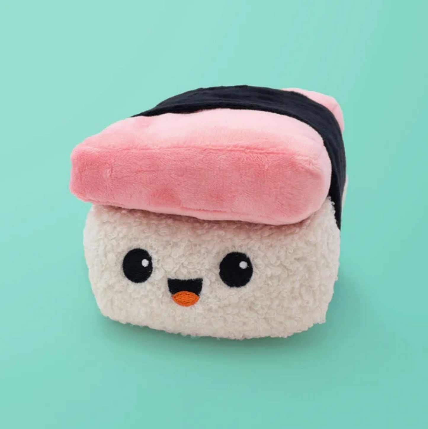 Plush toy resembling a piece of sushi with a pink rice ball on a light green background