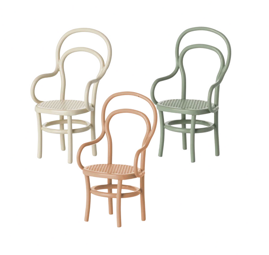 Three vintage-style chairs in different colors on a white background