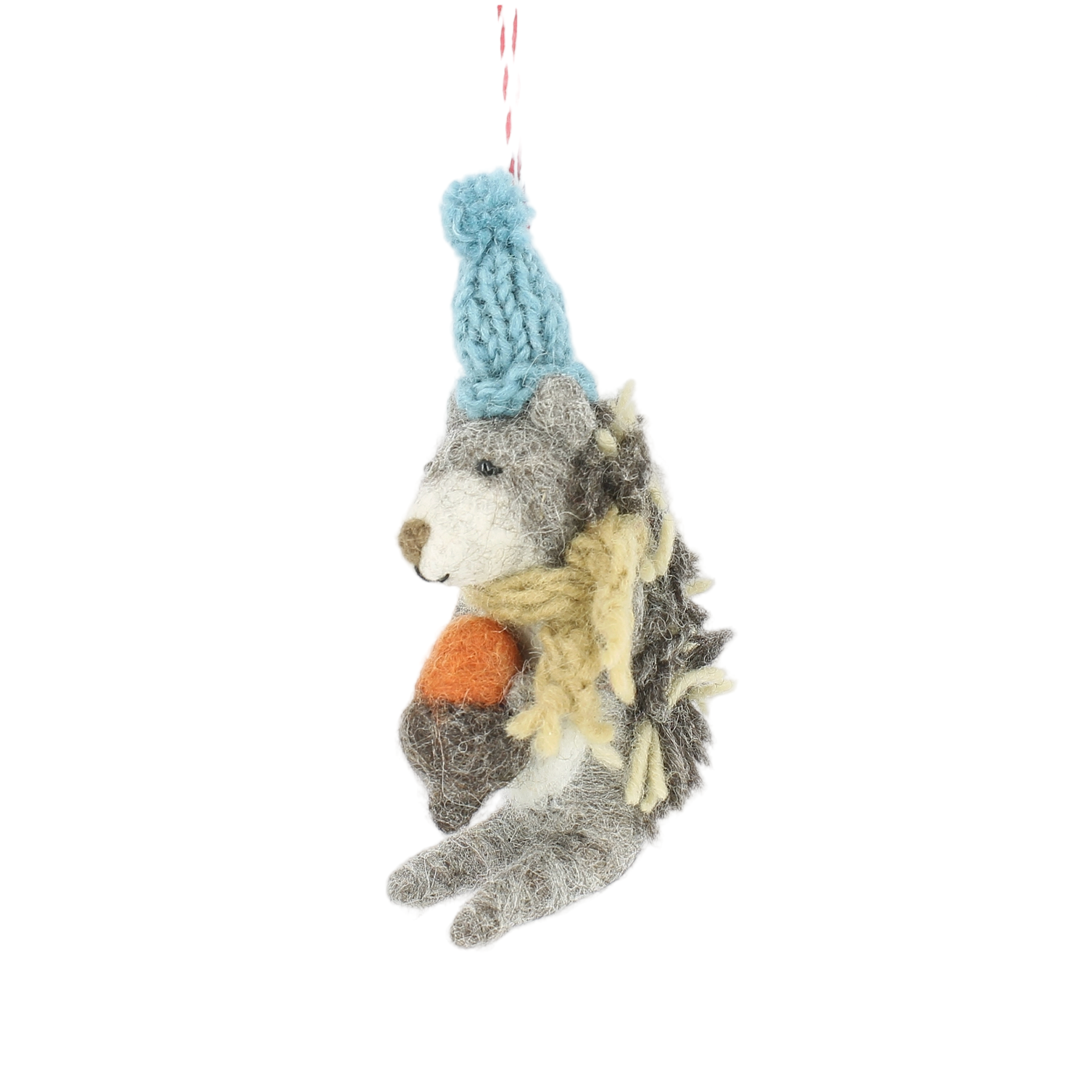 Plush toy hedgehog with a blue knitted hat on a white background