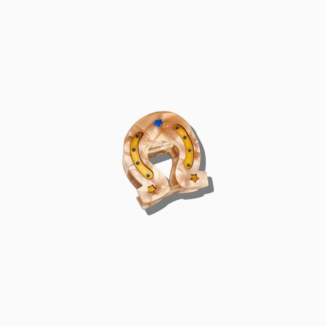 Gold horseshoe-shaped ring with embedded stones on a white background