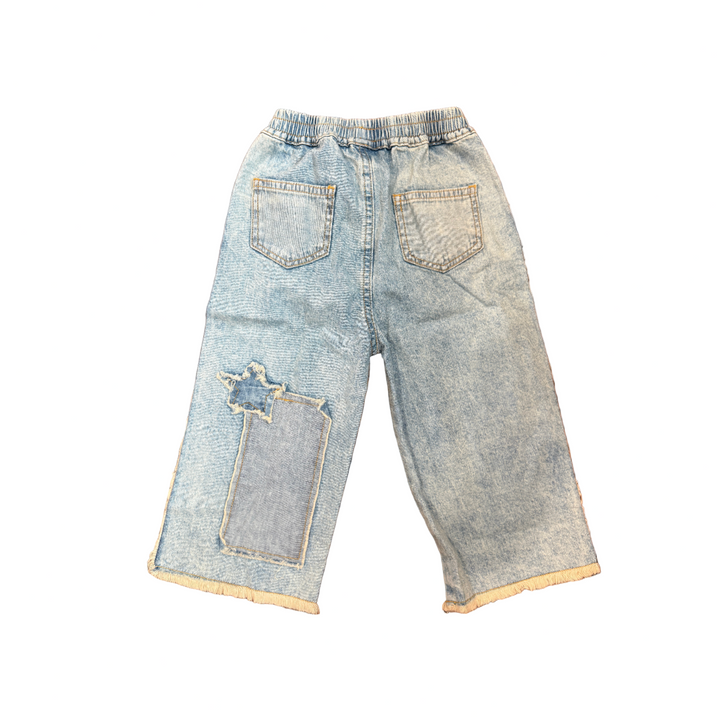 Pair of light blue jeans on a wooden surface