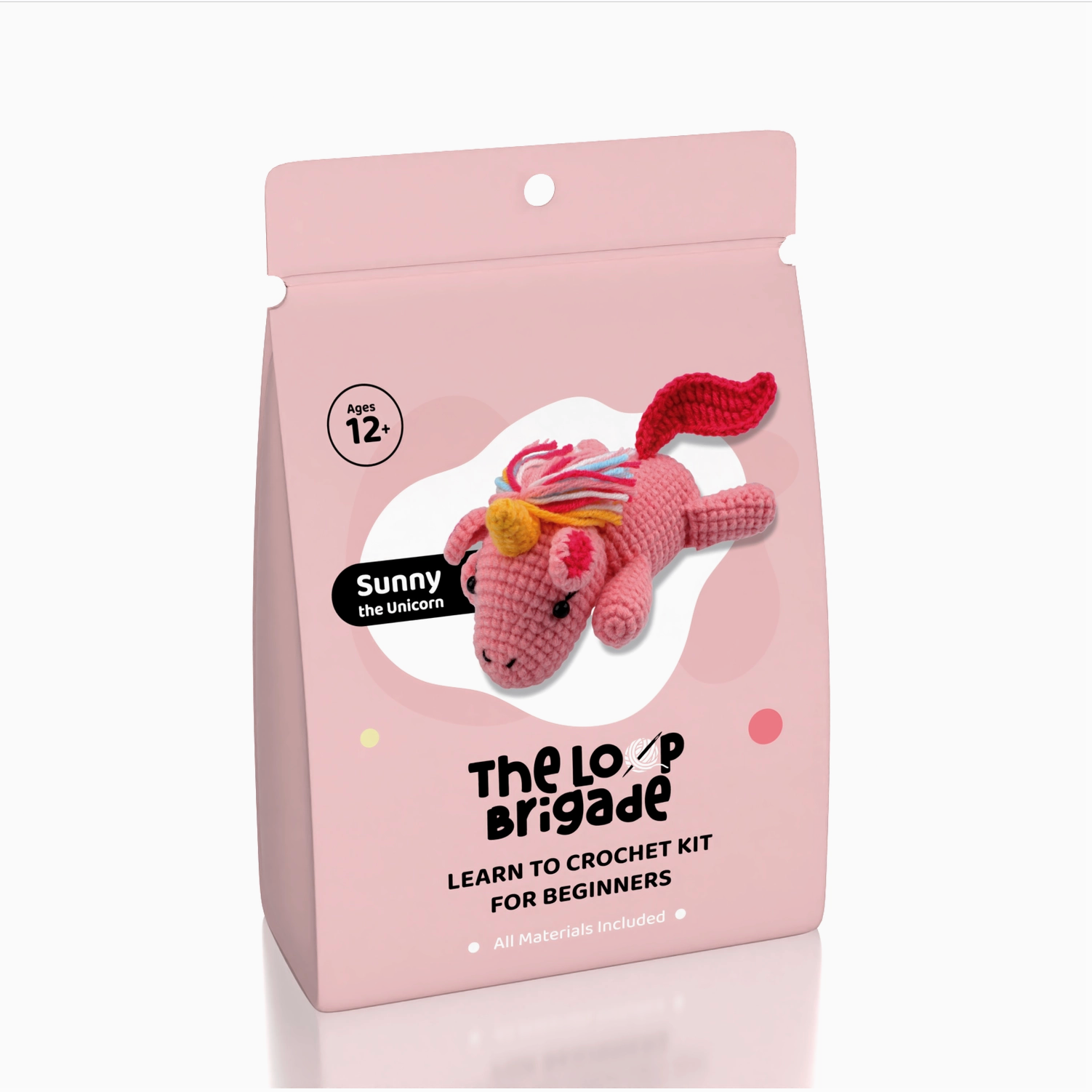 Crochet kit packaging with a pink unicorn toy on a white background